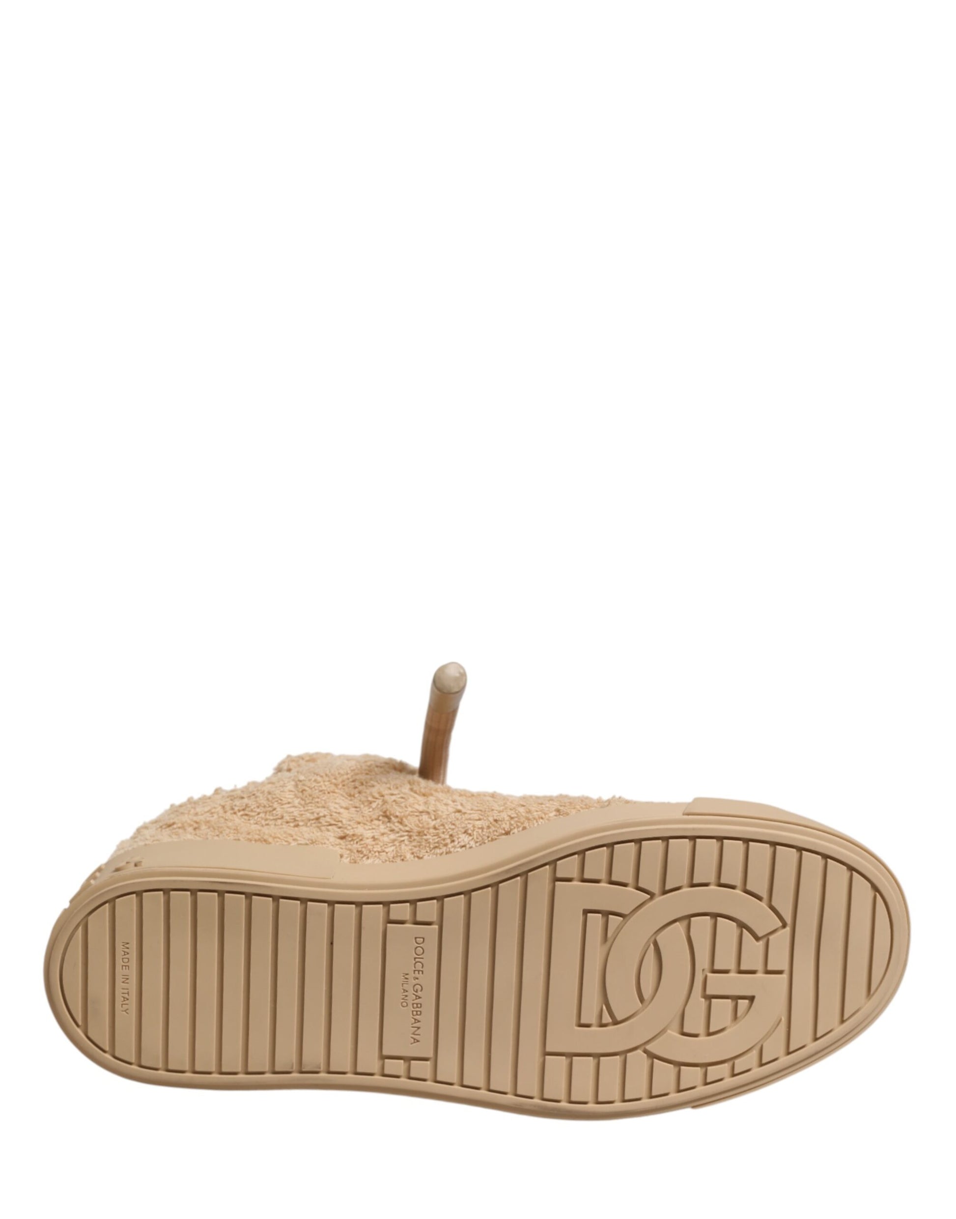 A pair of beige faux shearling low top sneakers with a logo on the side