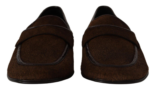 Pair of brown slippers with black trim and soles