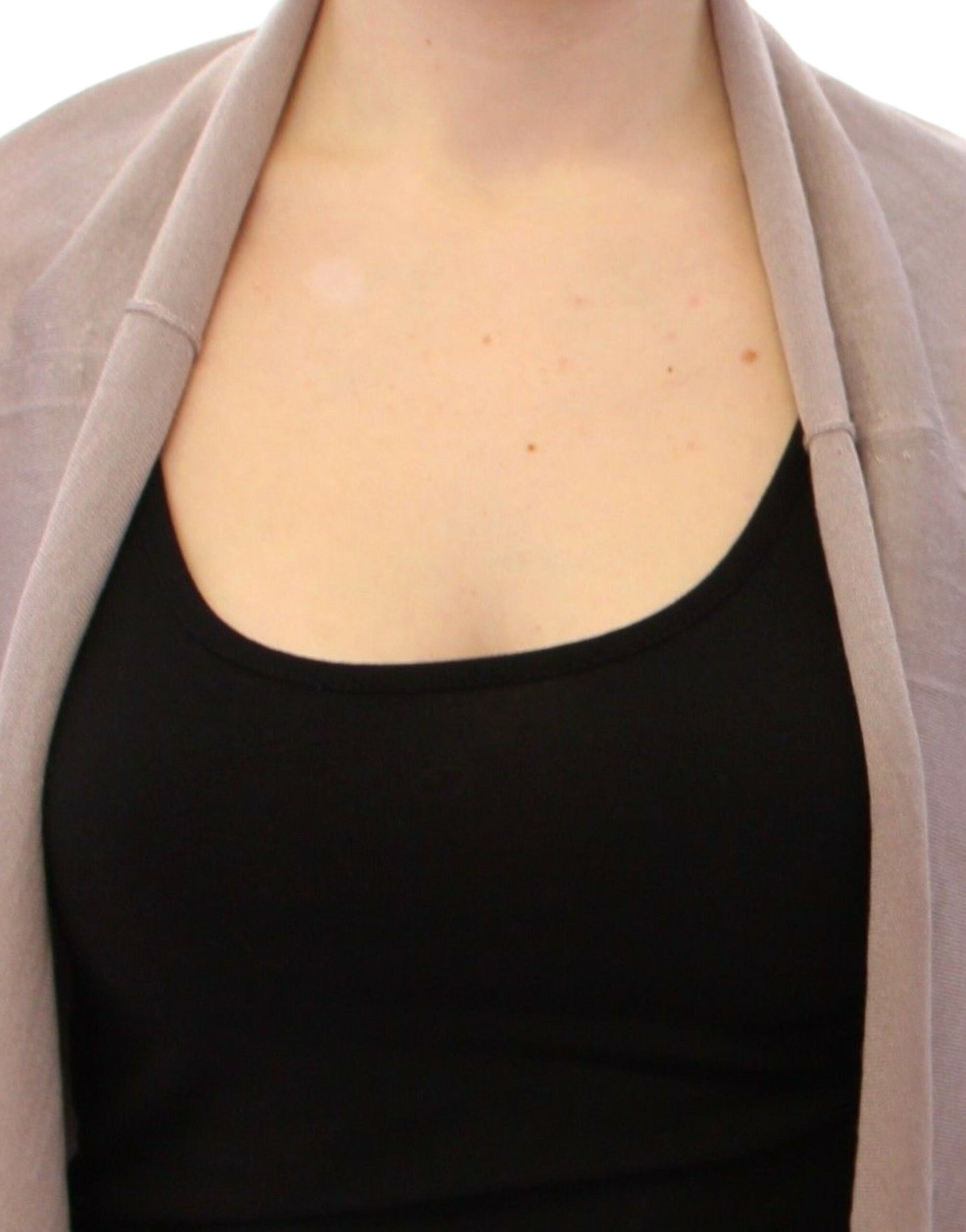Woman wearing black tank top and pink cardigan