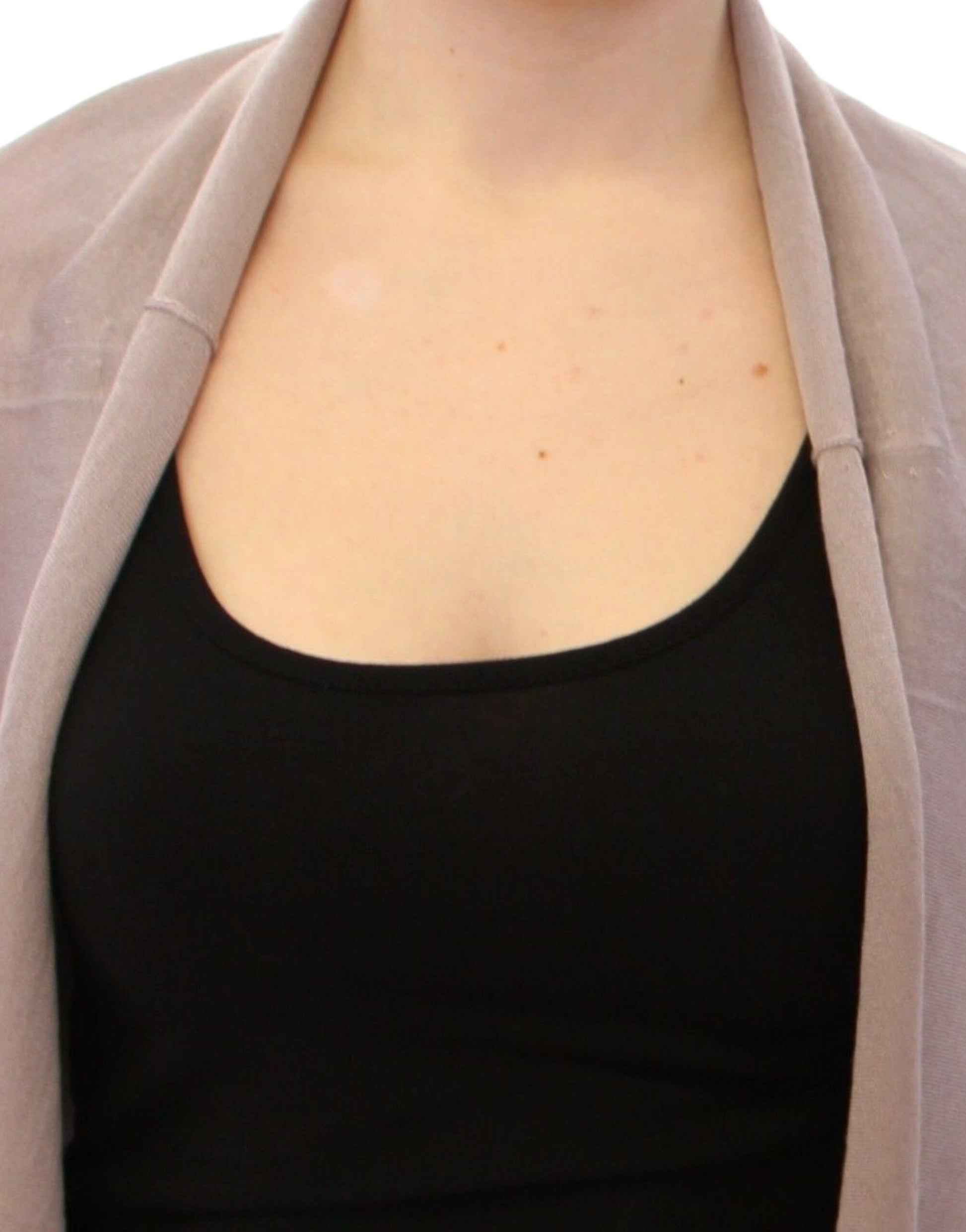 Woman wearing black tank top and beige cardigan