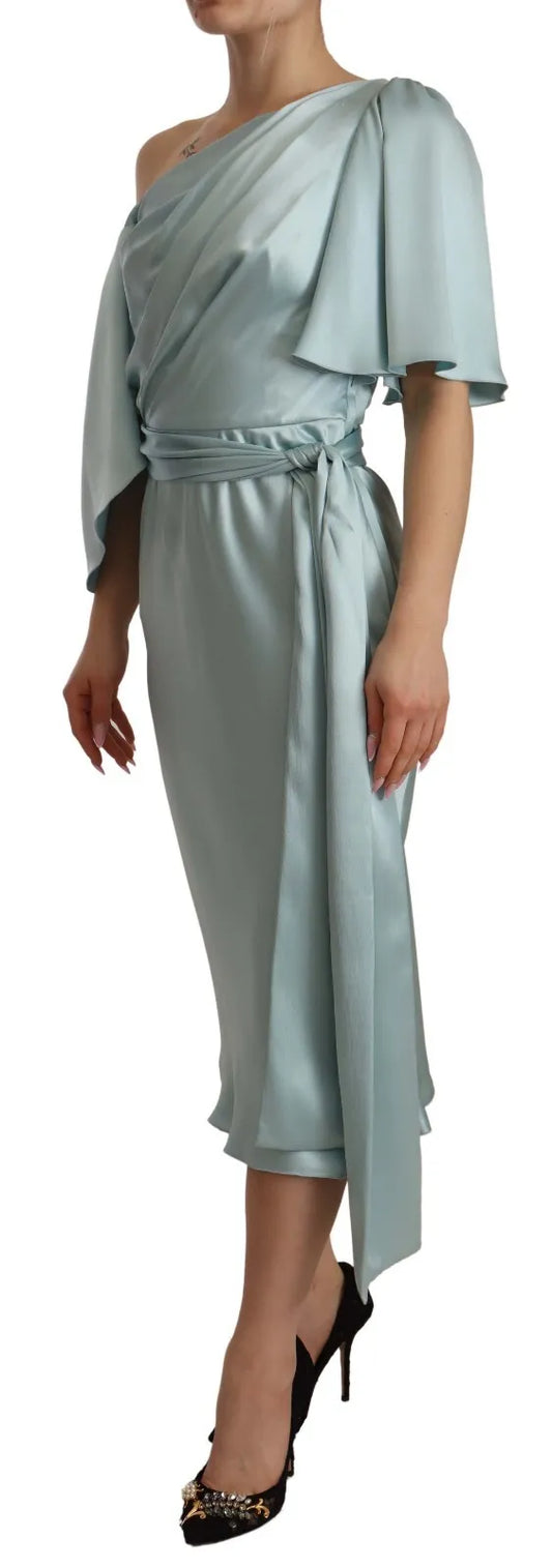 Woman wearing a long light blue dress with ruffles on sleeves