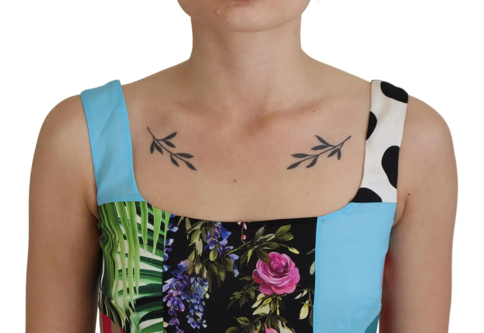 A woman wearing a blue, white and pink floral dress with patchwork design