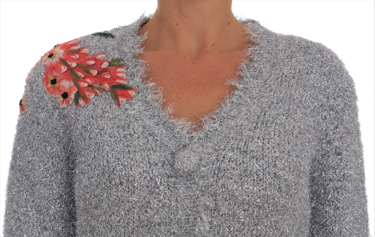 Silver sequined sweater with floral embellishment on shoulder