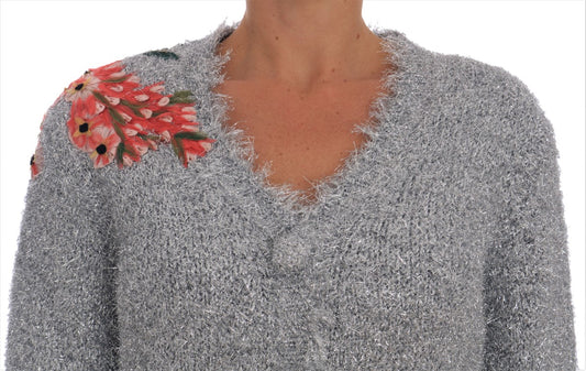 Silver sequined sweater with floral embellishment on shoulder