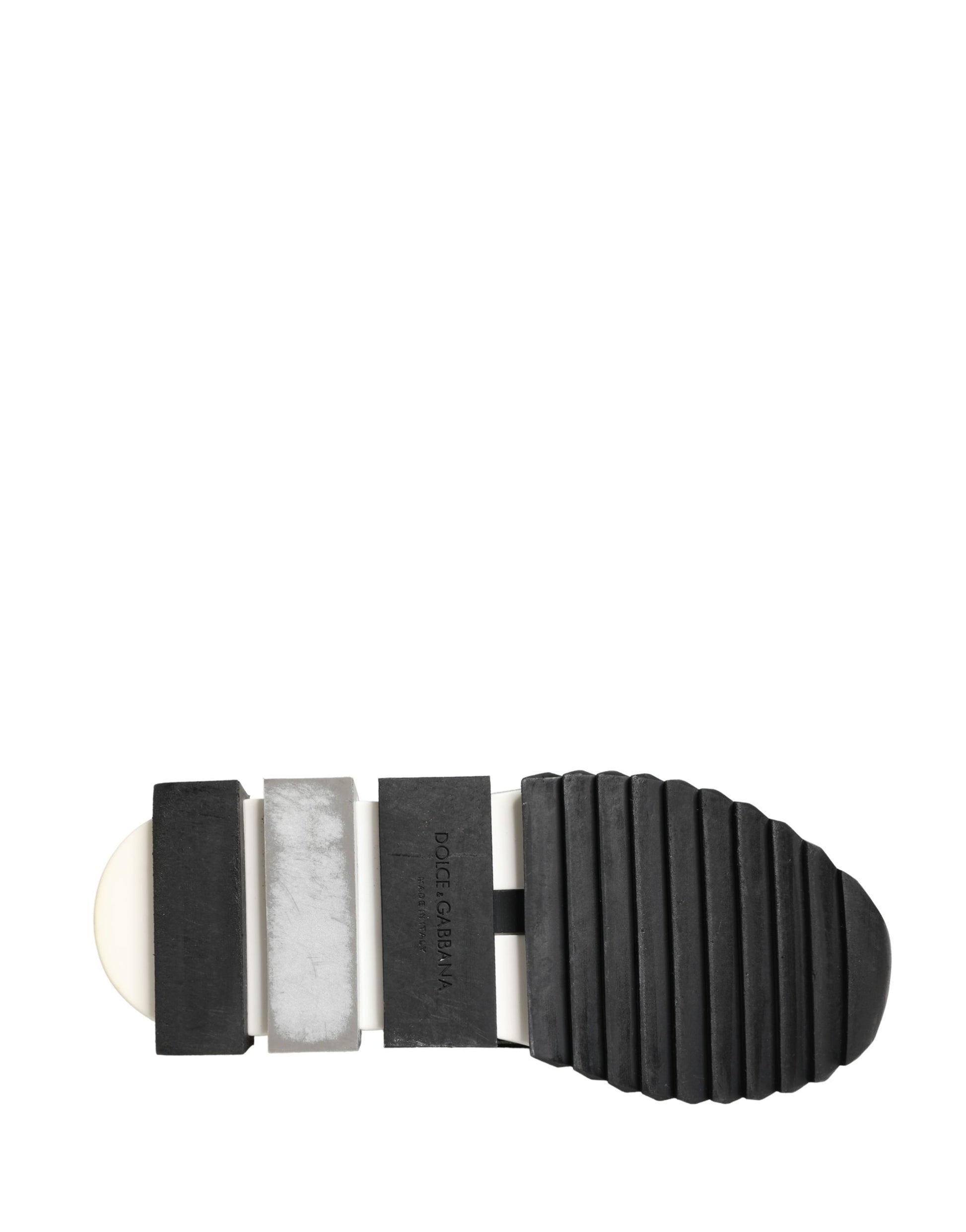 A pair of black slip-on shoes with a silver crystal logo on the side