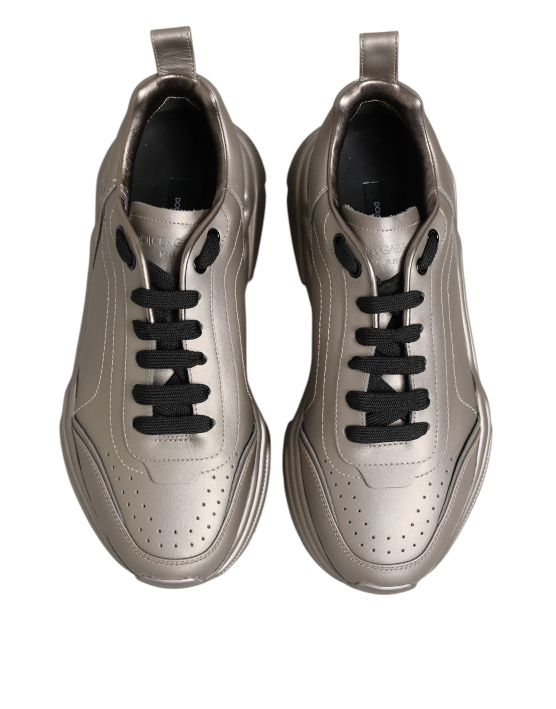 Pair of gold sneakers with black laces