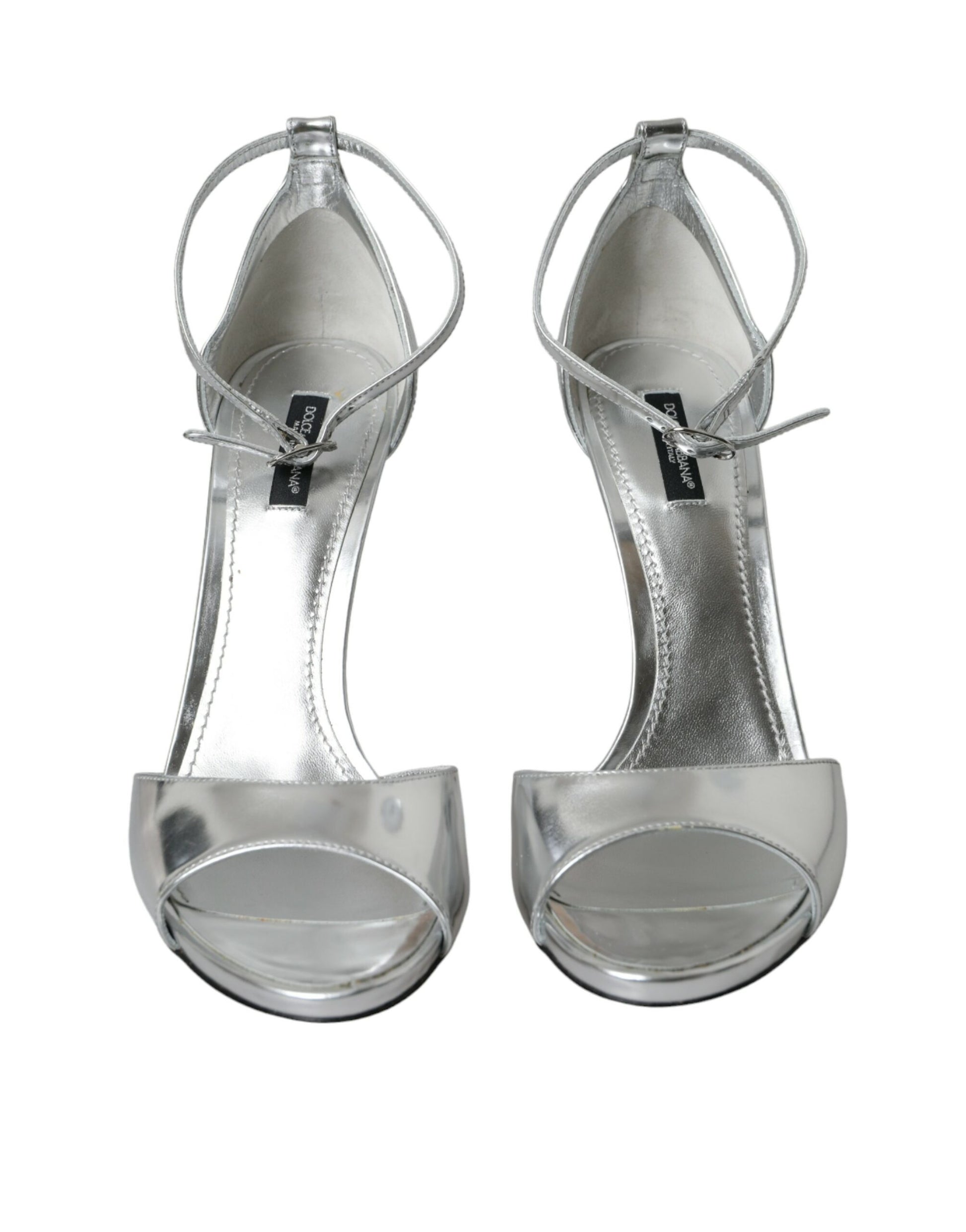 Pair of silver high heel shoes with ankle strap and bow detail