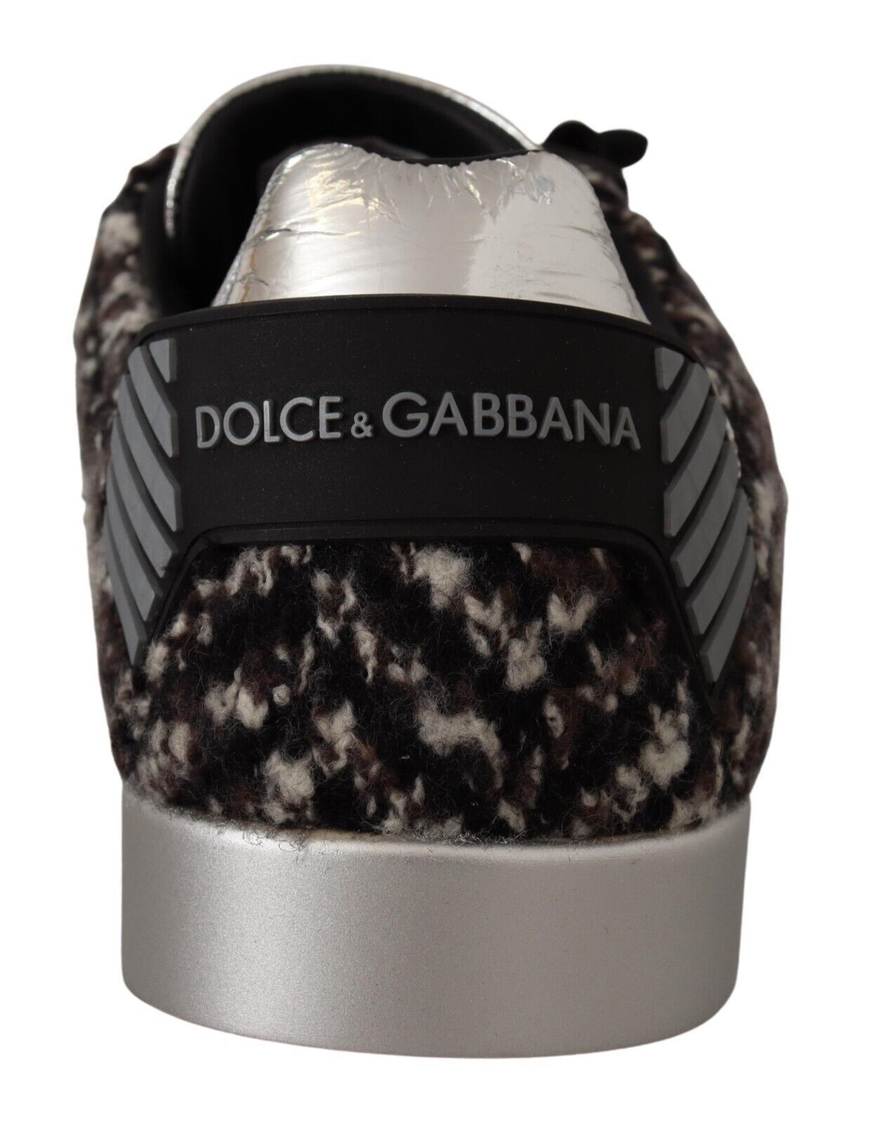 A single shoe against a plain background. The shoe features a furry texture on the upper part and has a silver sole with