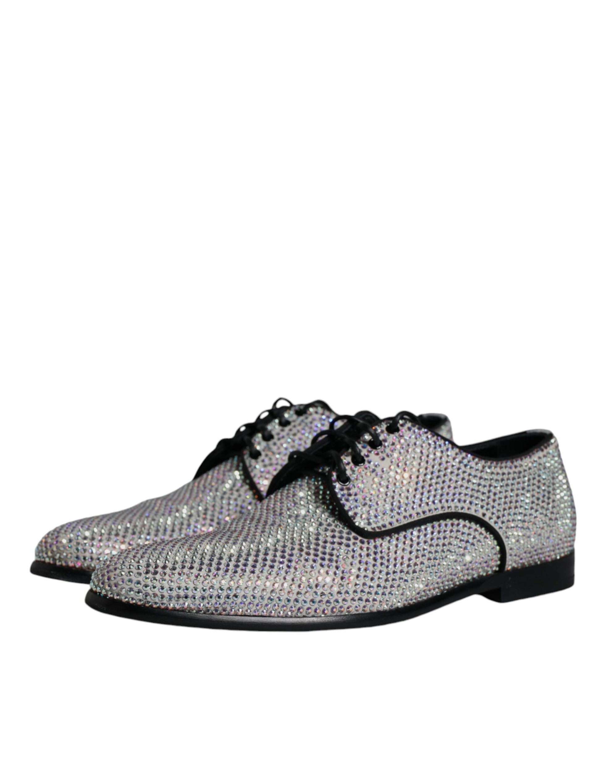 A pair of silver leather rhinestone dress shoes with a bow tie design