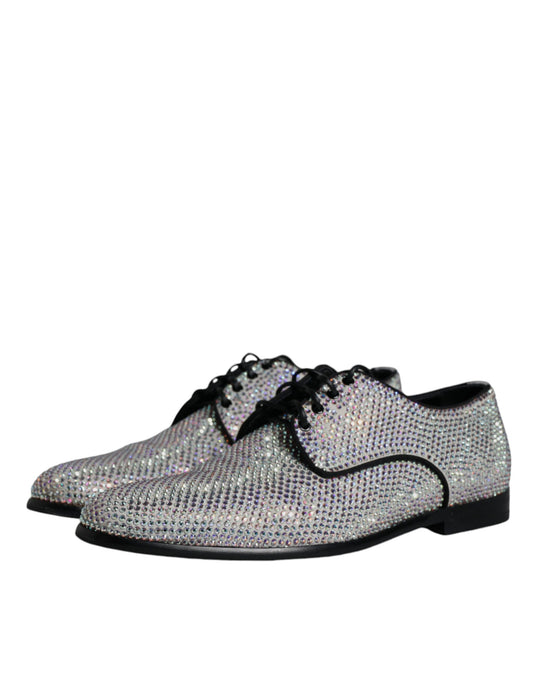 A pair of silver leather rhinestone dress shoes with a bow tie design