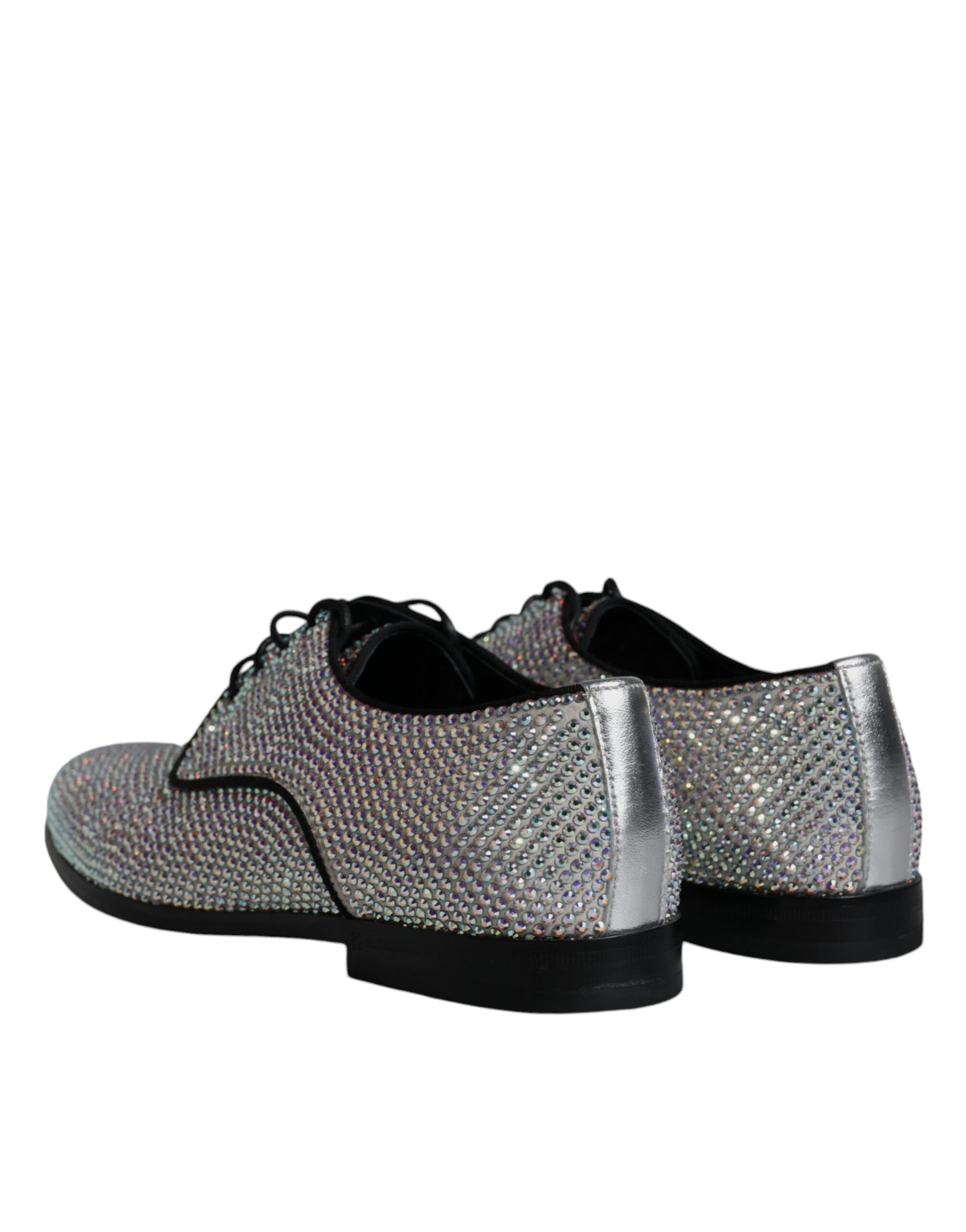 A pair of glittery silver leather shoes with rhinestone embellishments, featuring a lace-up design and chunky soles
