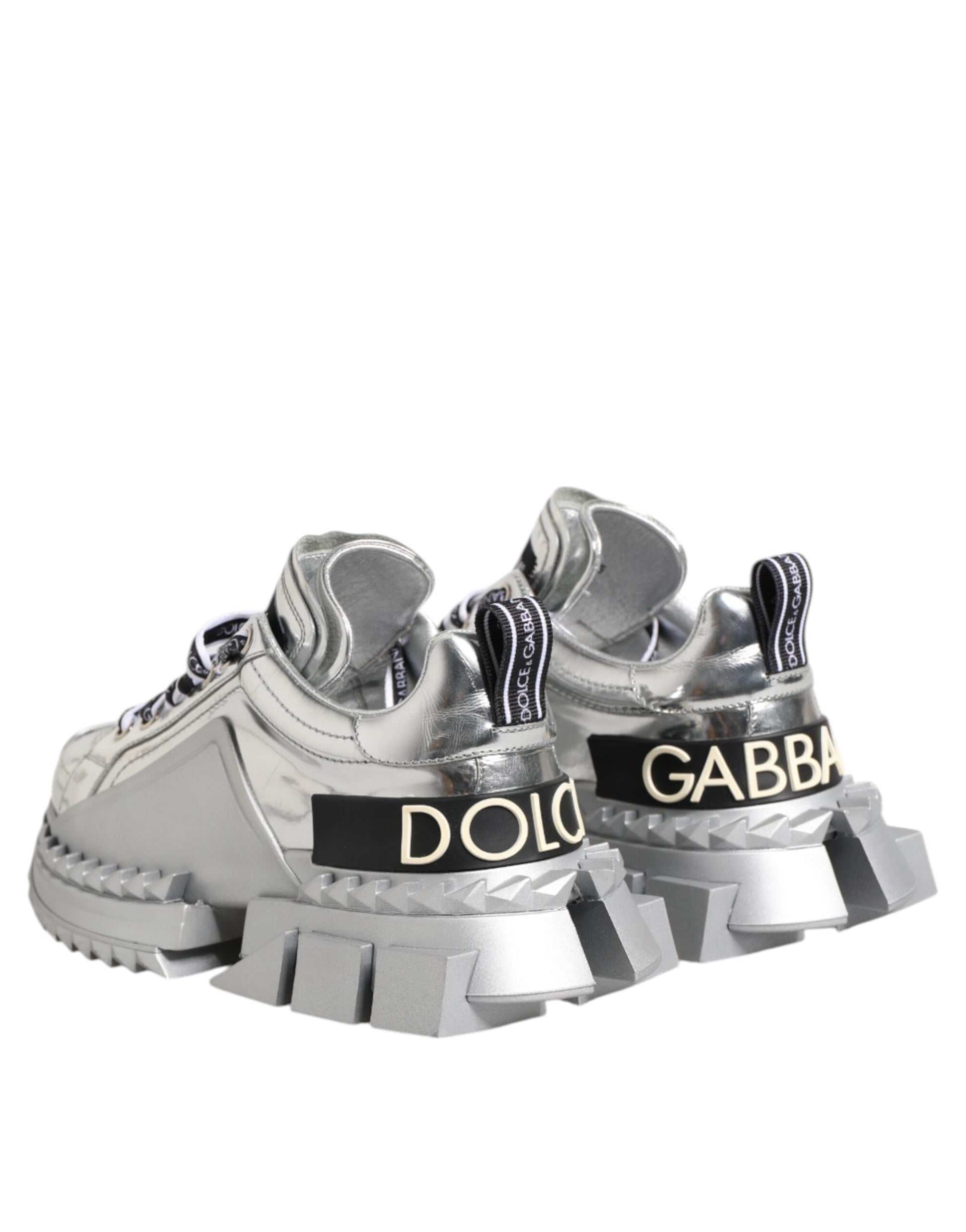 Pair of silver sneakers with black laces and white soles