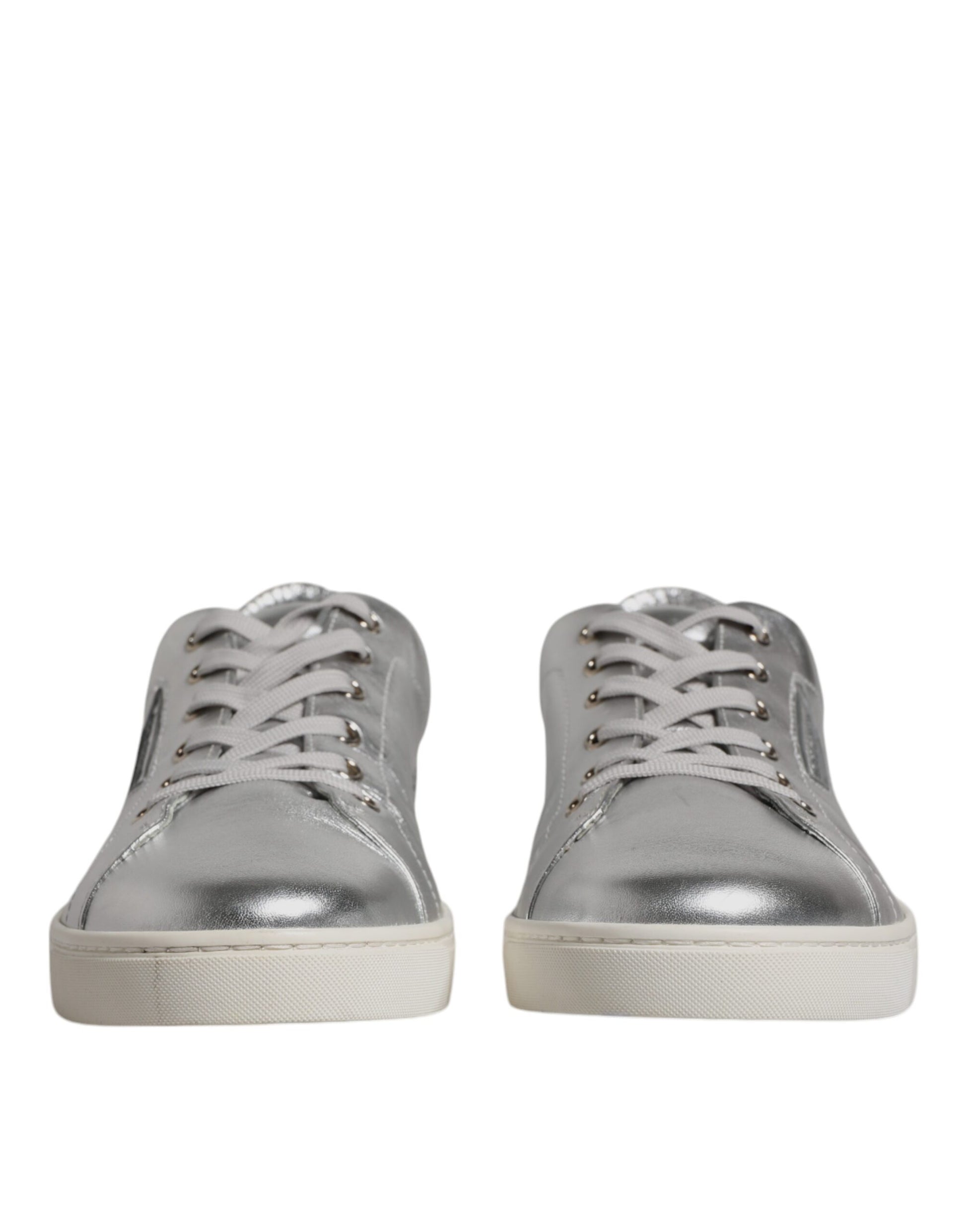 Pair of silver leather sneakers with laces and a low top, featuring the brand name on side
