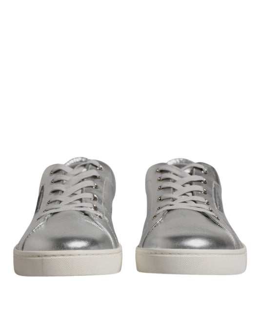 Pair of silver leather sneakers with laces and a low top, featuring the brand name on side