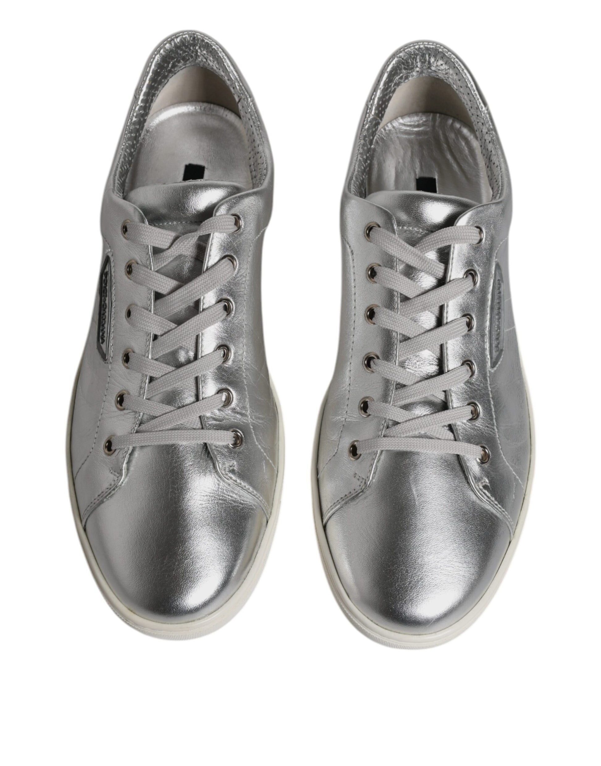 Pair of silver leather sneakers with laces and a low top, featuring the Dolce & Gabbana logo