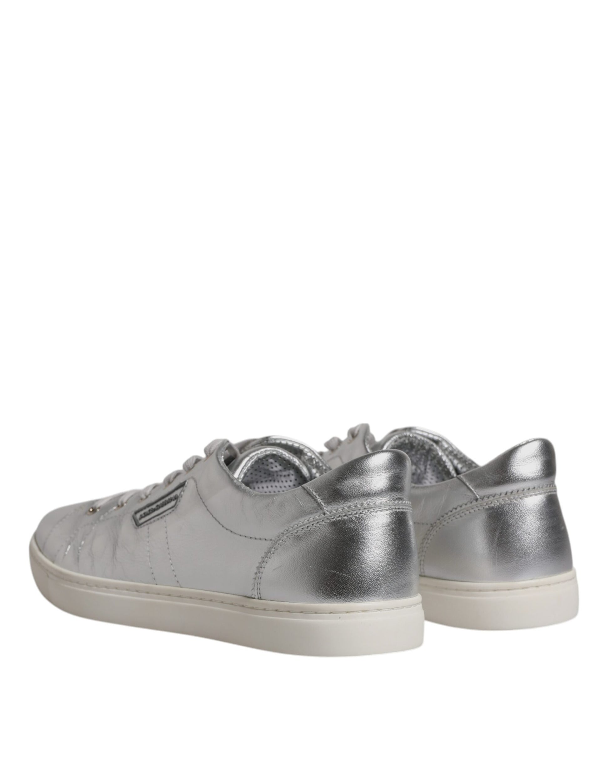 A pair of silver glittery sneakers with a low top, featuring laces and a flat sole