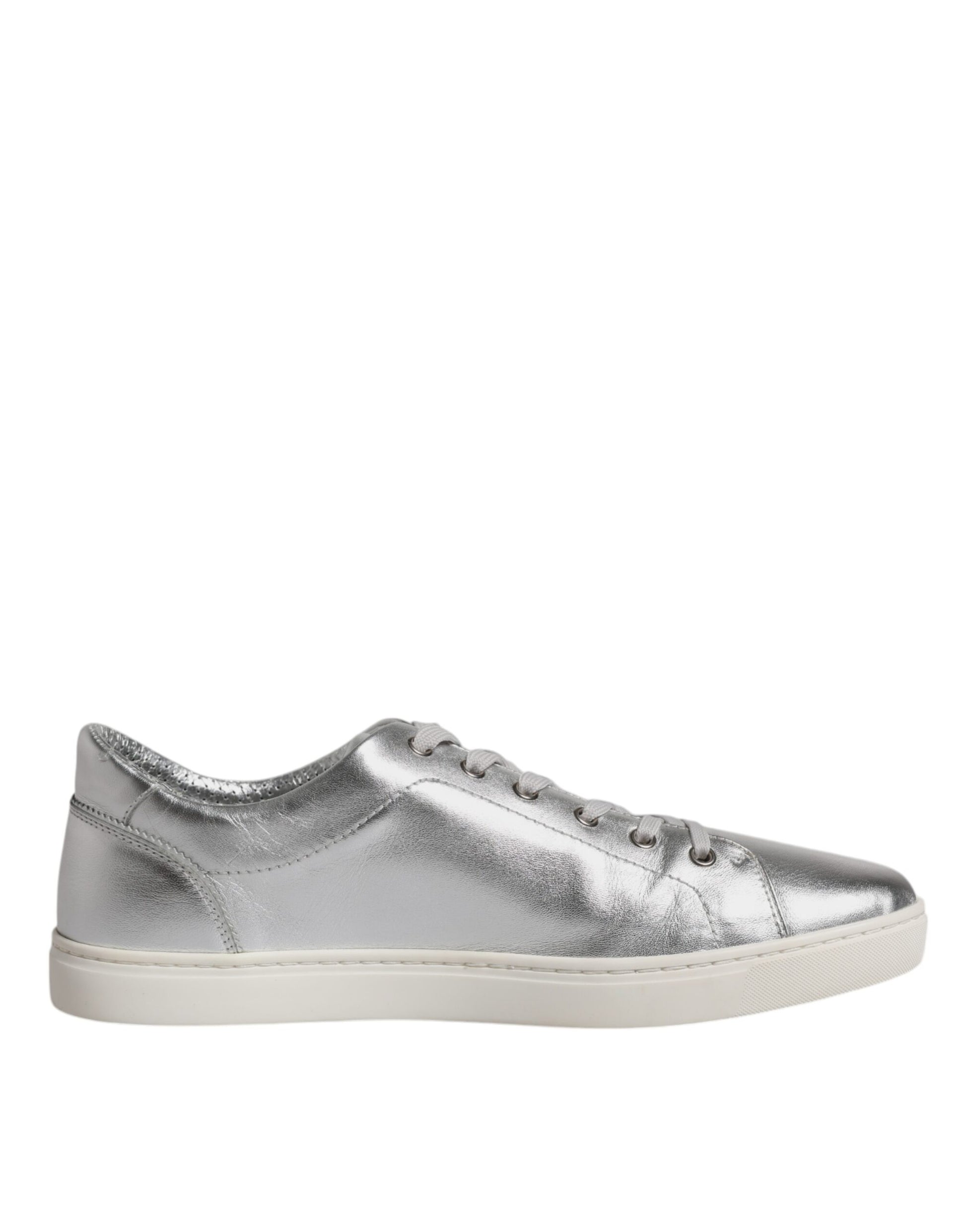 A pair of silver glittery sneakers with a low top and laces, featuring the brand name "Dolce & Gabbana" on the side