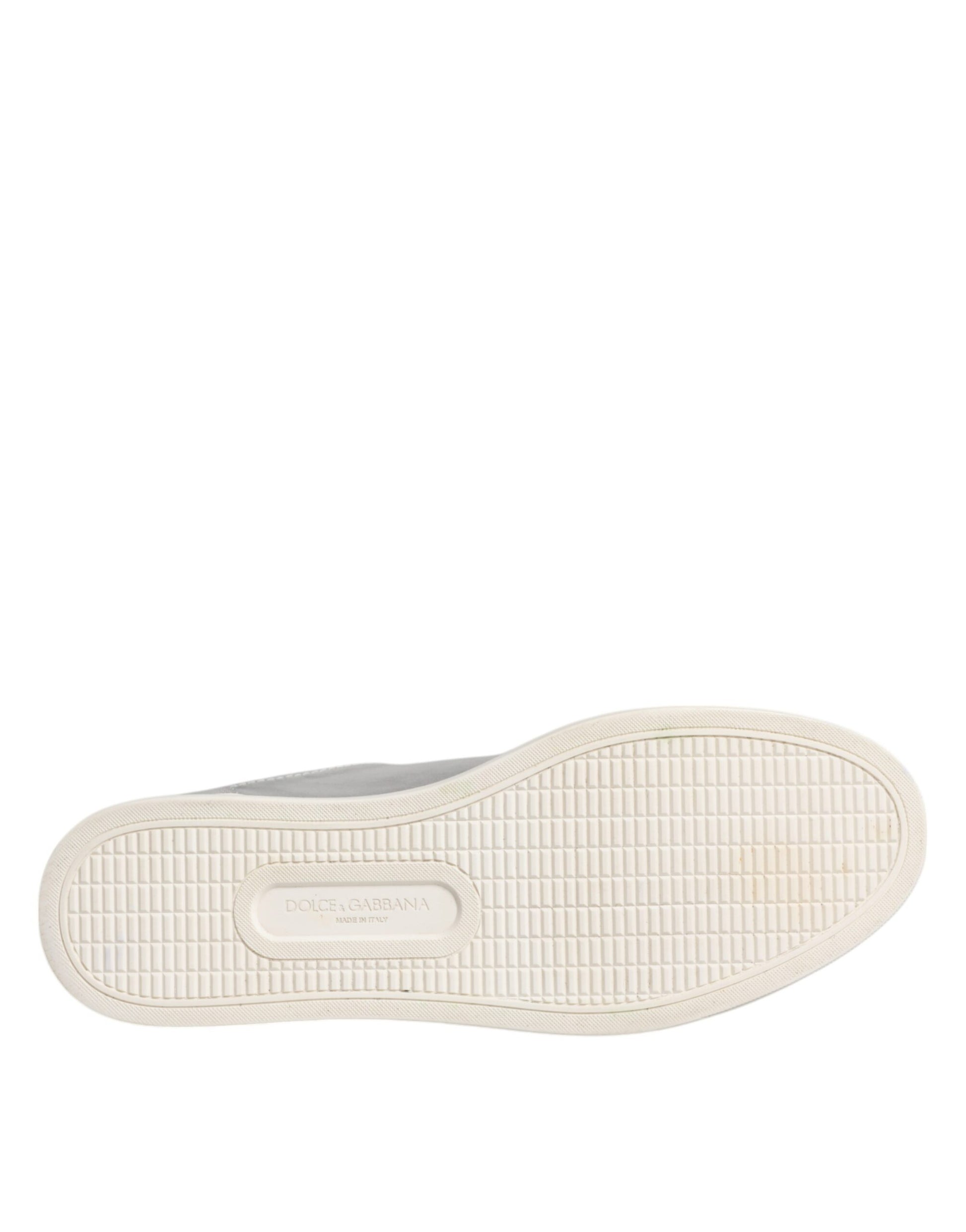 A single shoe from the Dolce & Gabbana brand, featuring a low top design and silver color. The shoe is made of leather and ha