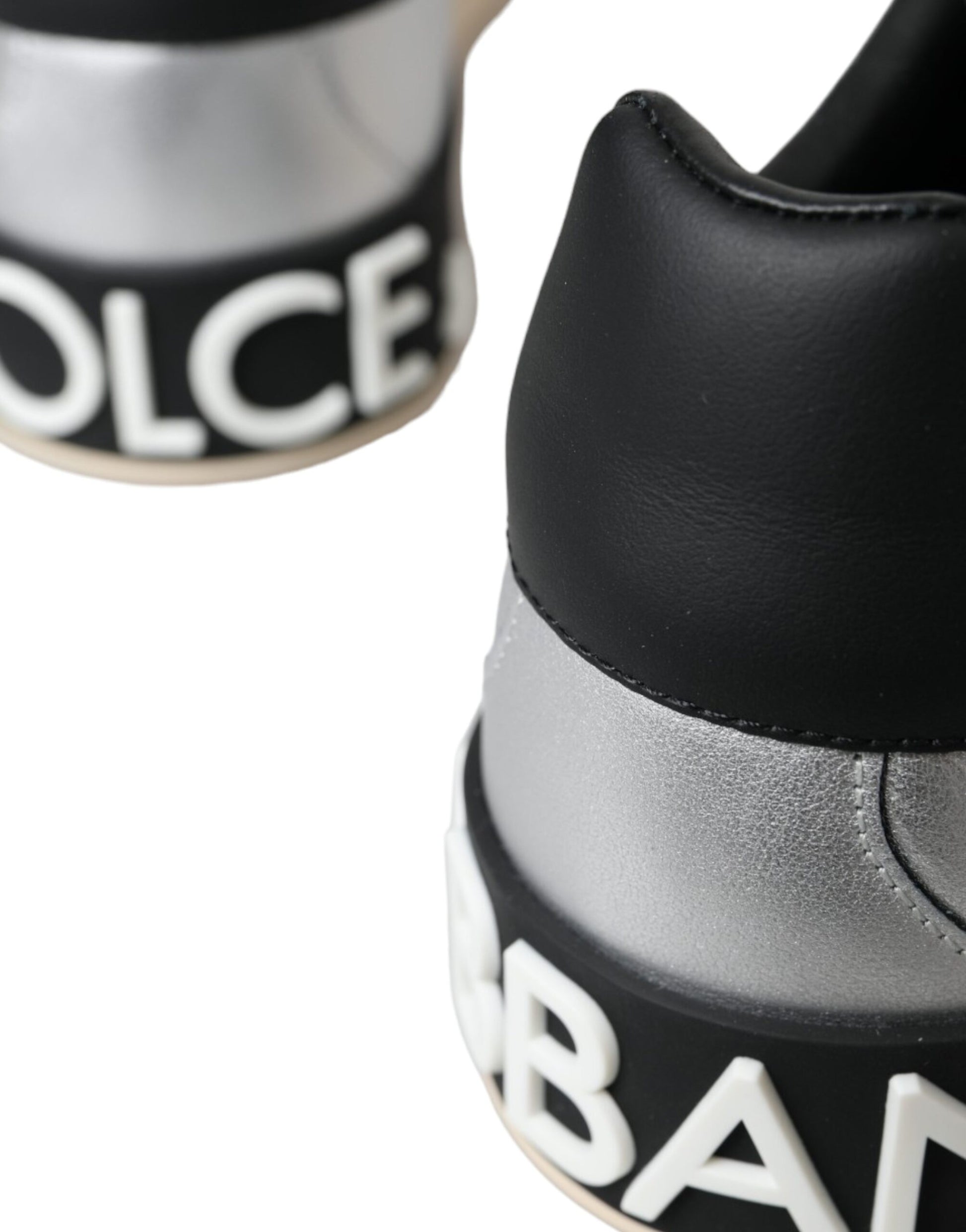 Black and white sneaker with silver accents and text reading BURBERRY