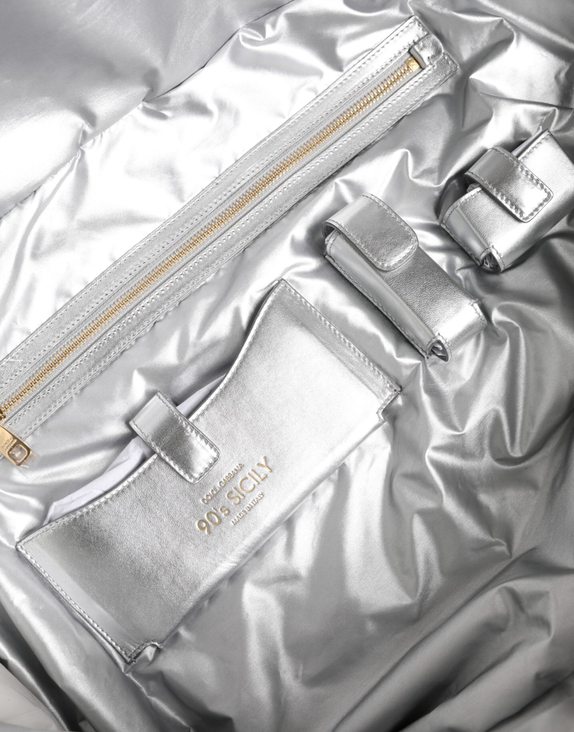 Silver metallic clutch purse with gold zipper pulls