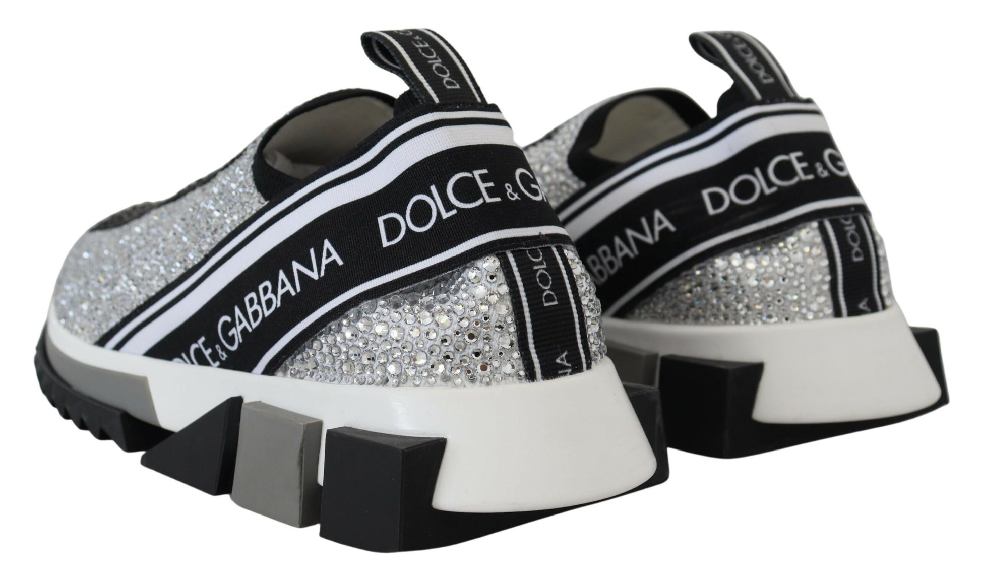 A pair of silver rhinestone sneakers with black laces and a white sole