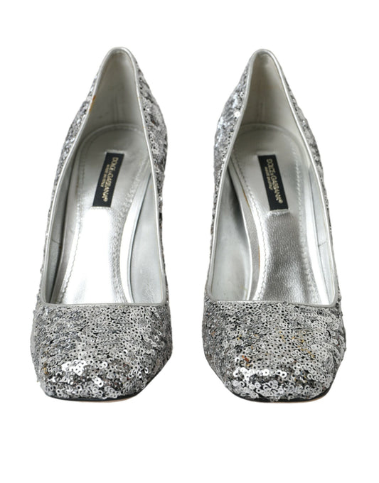Pair of silver glittery women's shoes with a pointed toe and a small heel