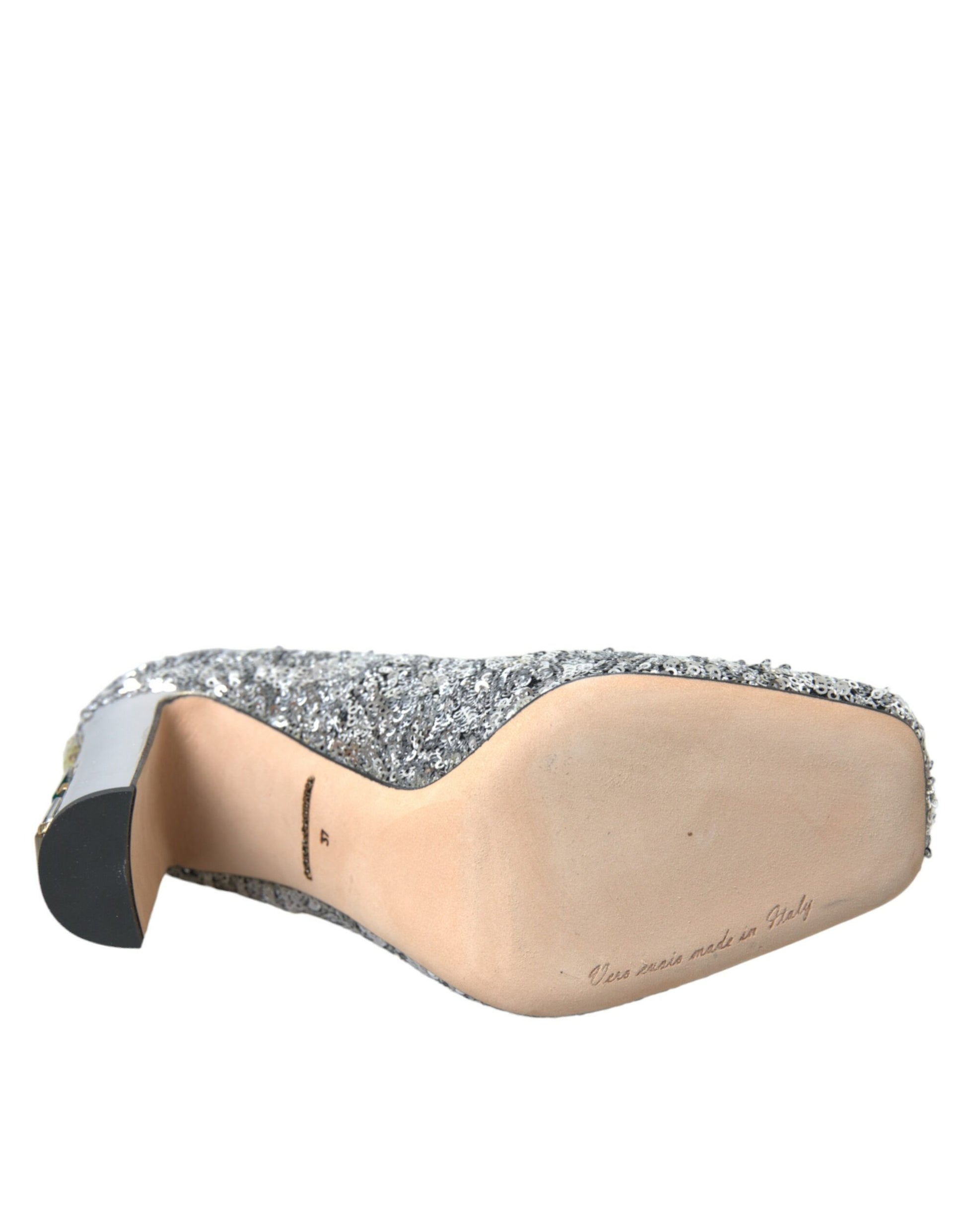 Brown shoe with a pointed toe and a strap across the top