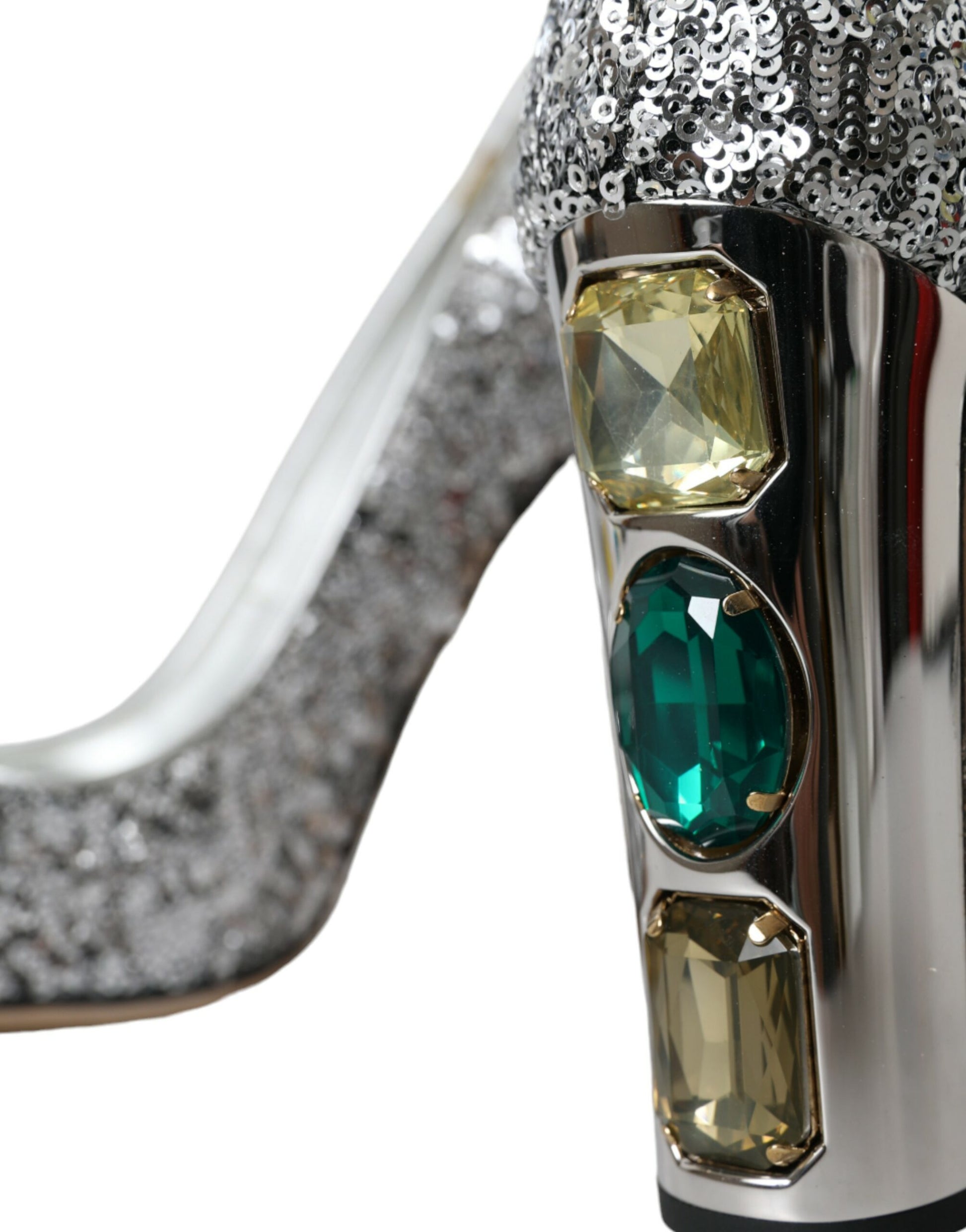 Silver high heel shoe with green gemstones on the toe and heel