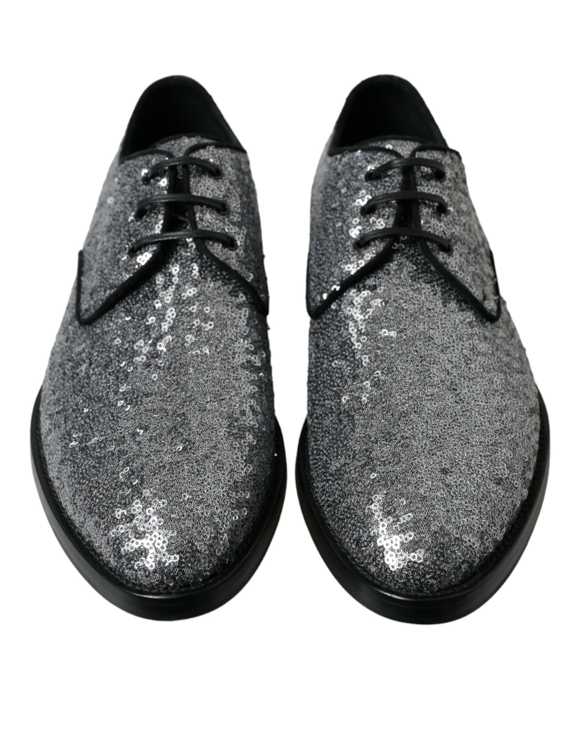 Pair of glittery silver shoes with laces and a low heel