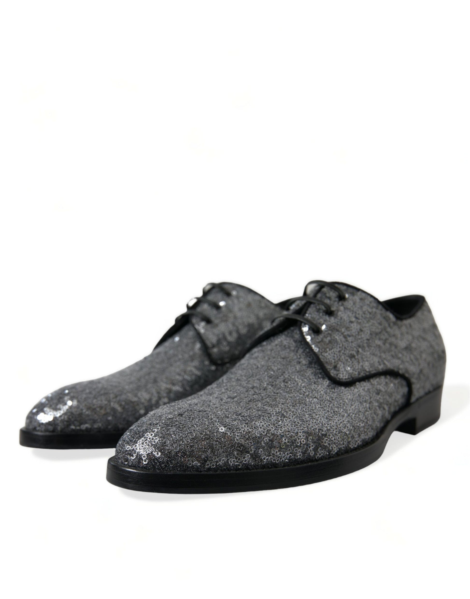 Pair of glittery silver shoes with black soles and laces