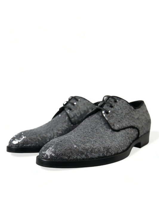 Pair of glittery silver shoes with black soles and laces