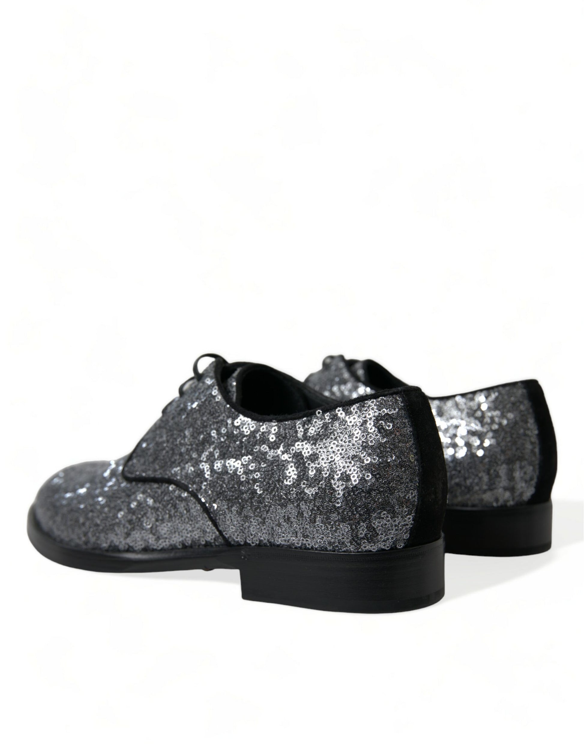 Pair of glittery silver shoes with black soles and laces