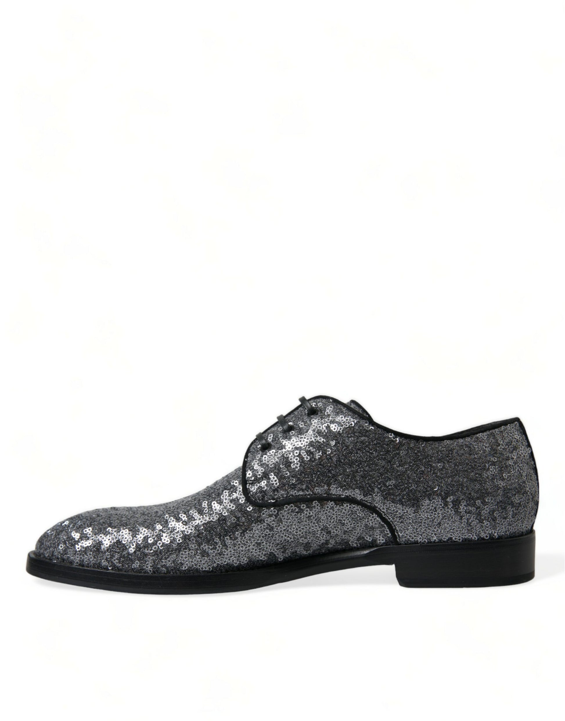 Pair of glittery silver shoes with black soles and laces