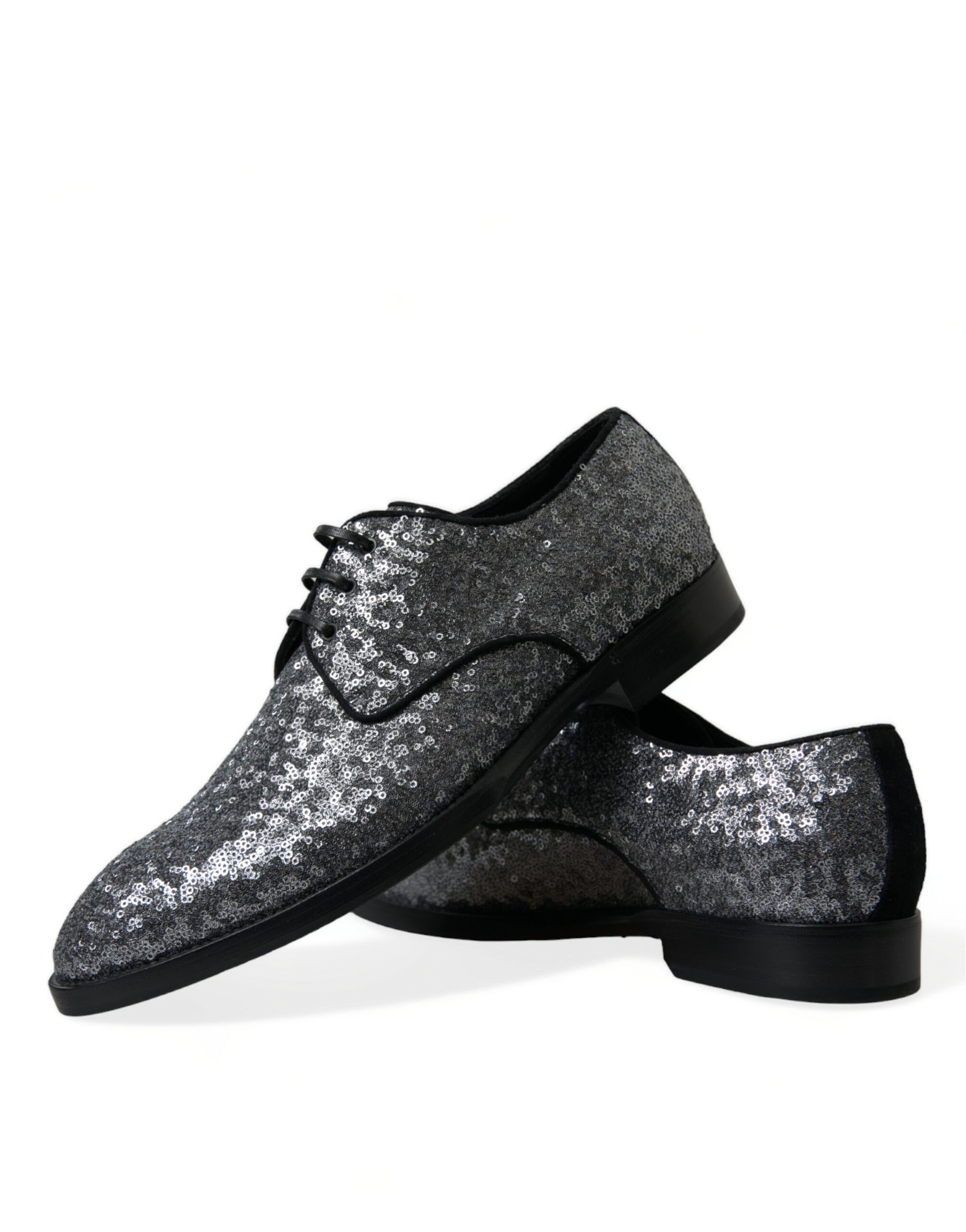 Pair of glittery silver shoes with black soles and laces