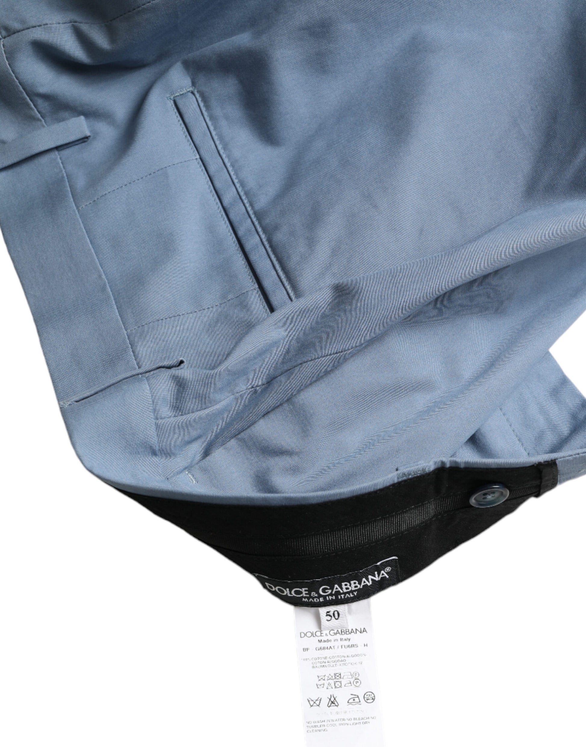 A pair of men's blue cotton shorts with a folded hem and tag