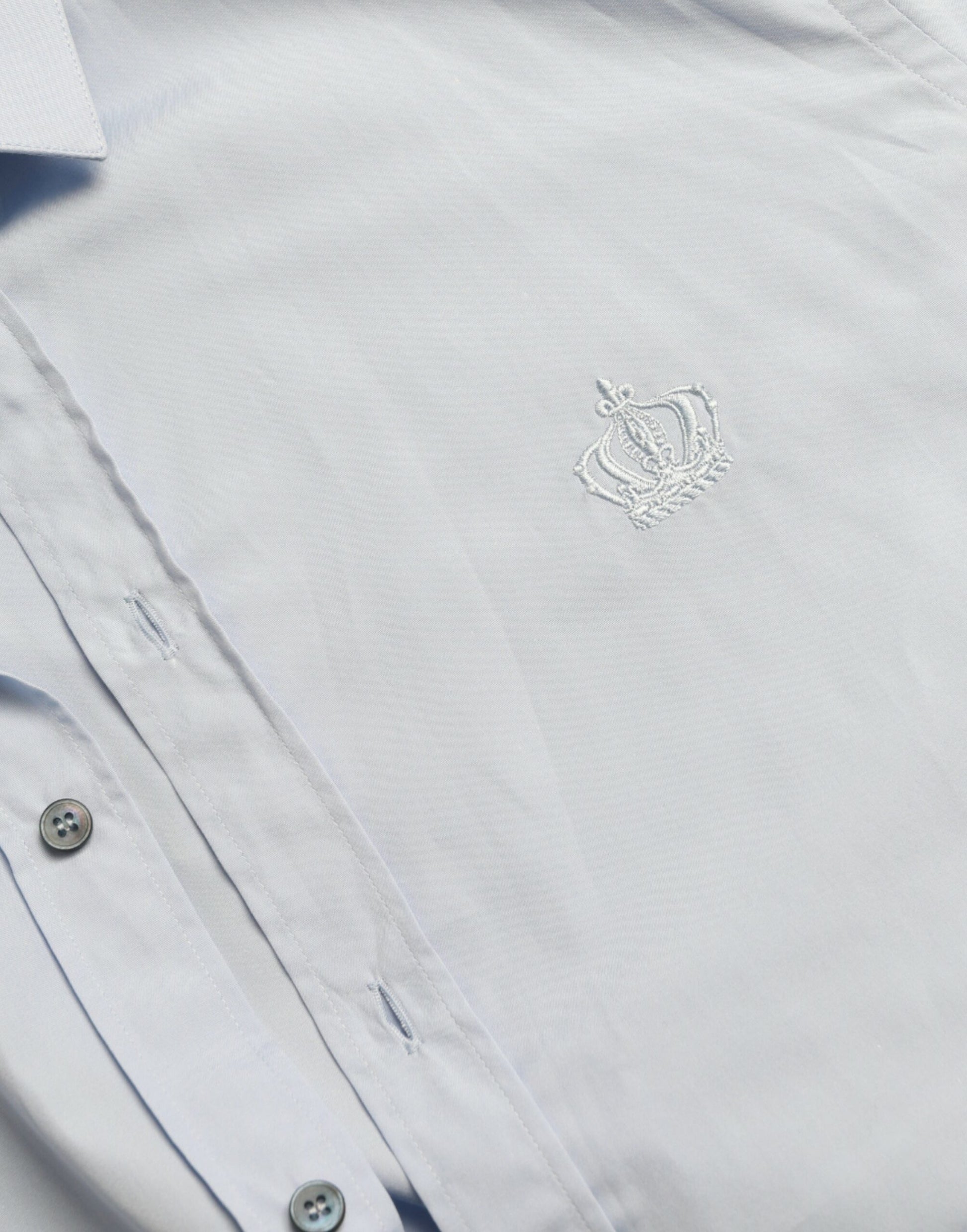 White shirt with embroidered emblem on left chest