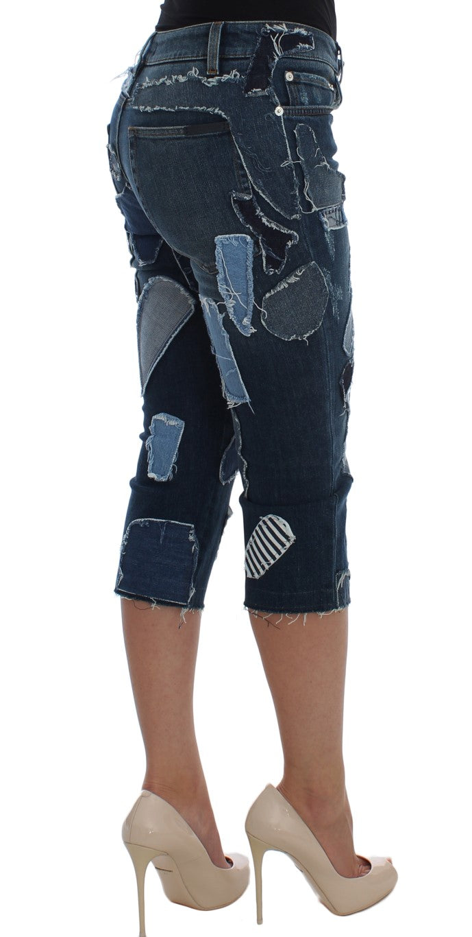 Pair of distressed denim shorts with rips and patches on legs