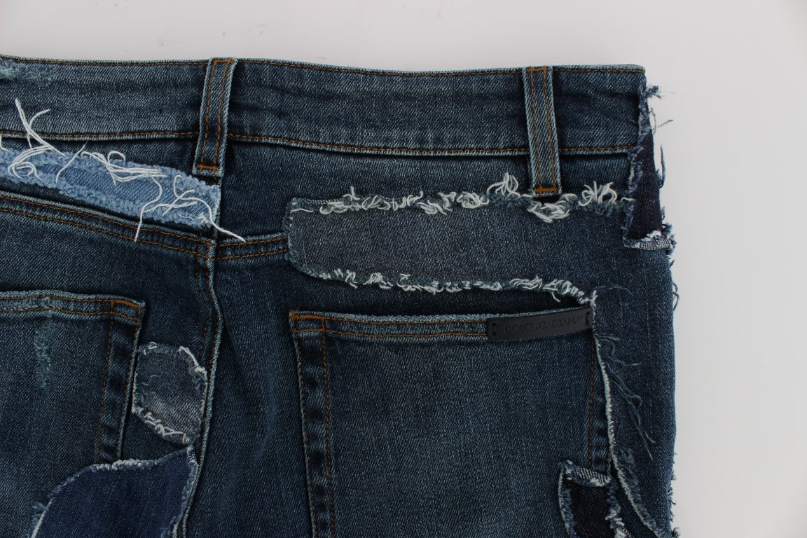 Pair of distressed blue jeans with frayed edges and patches