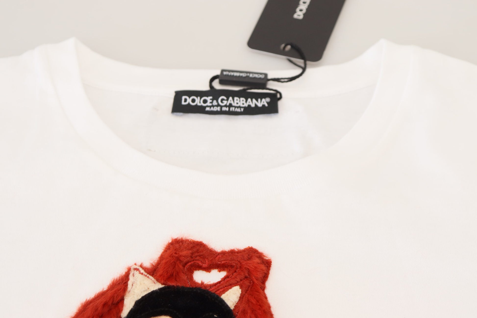 White t-shirt with red embroidery on front