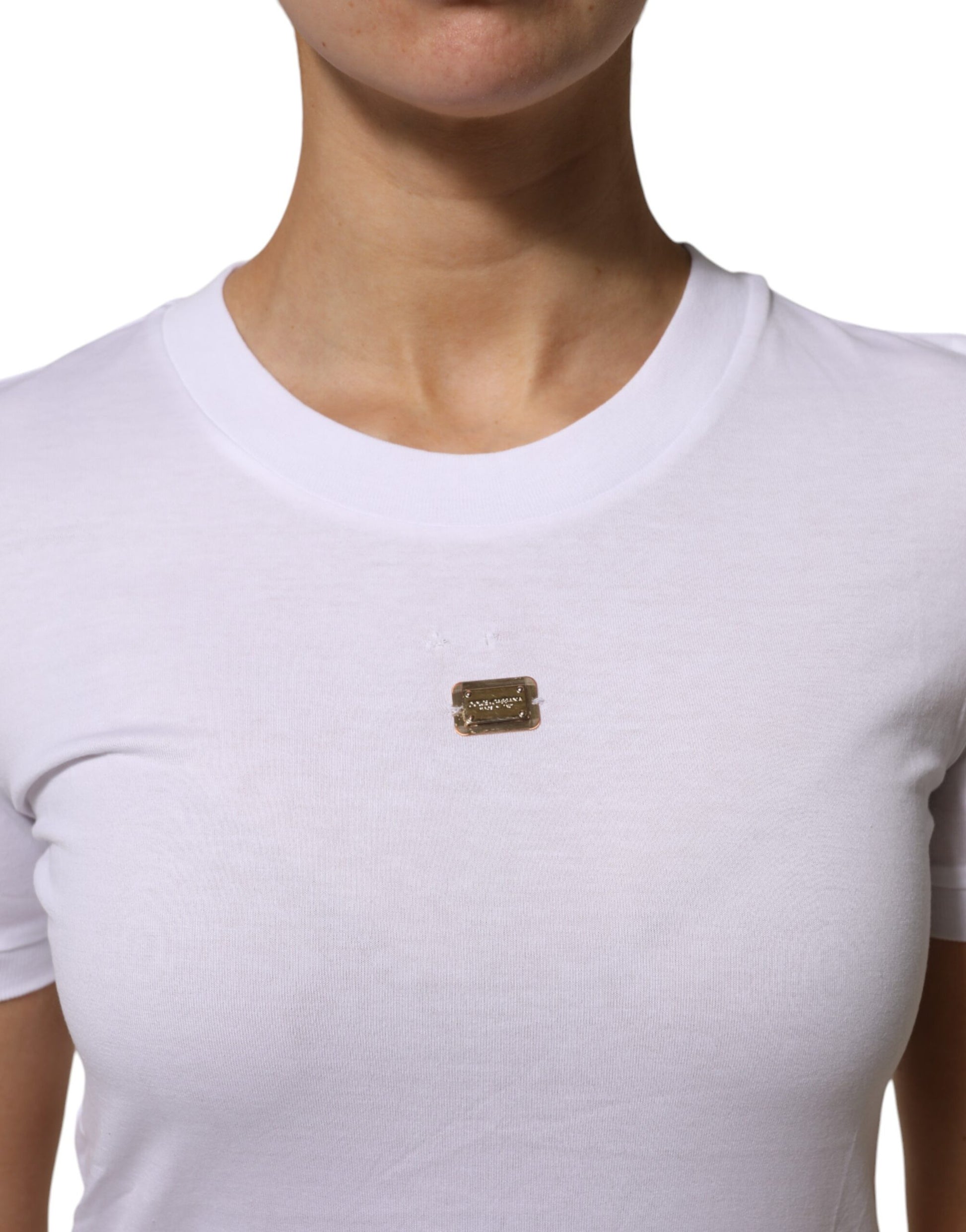 White t-shirt with a small badge on the left chest area