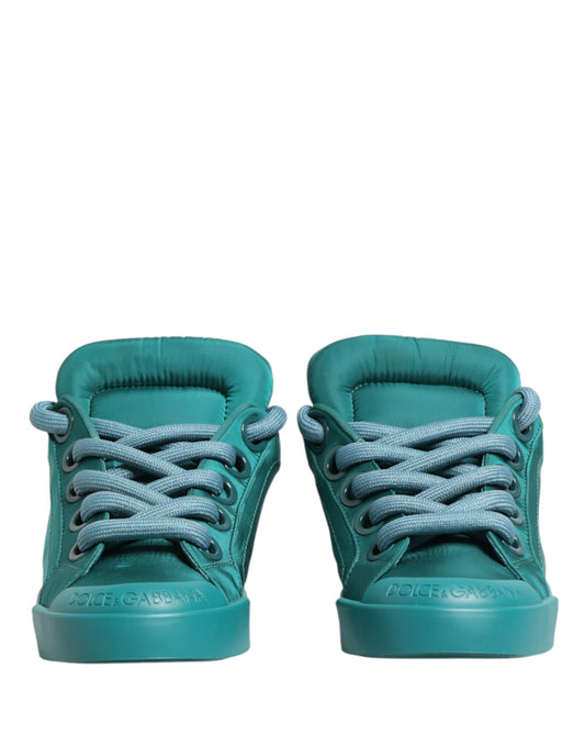 A pair of teal men's low top sneakers with white laces and a white logo on the side