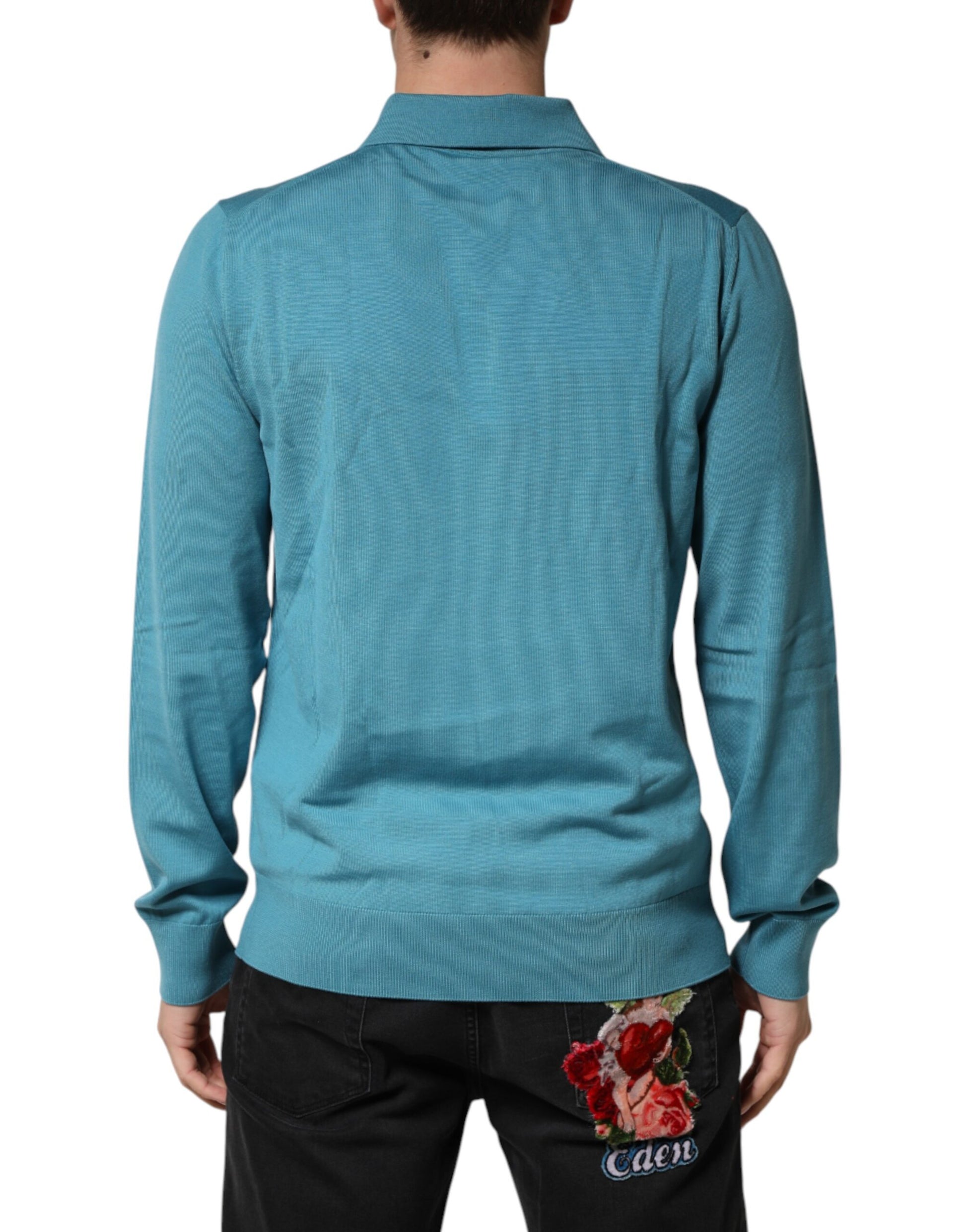 Man wearing blue shirt and jeans with floral design on back