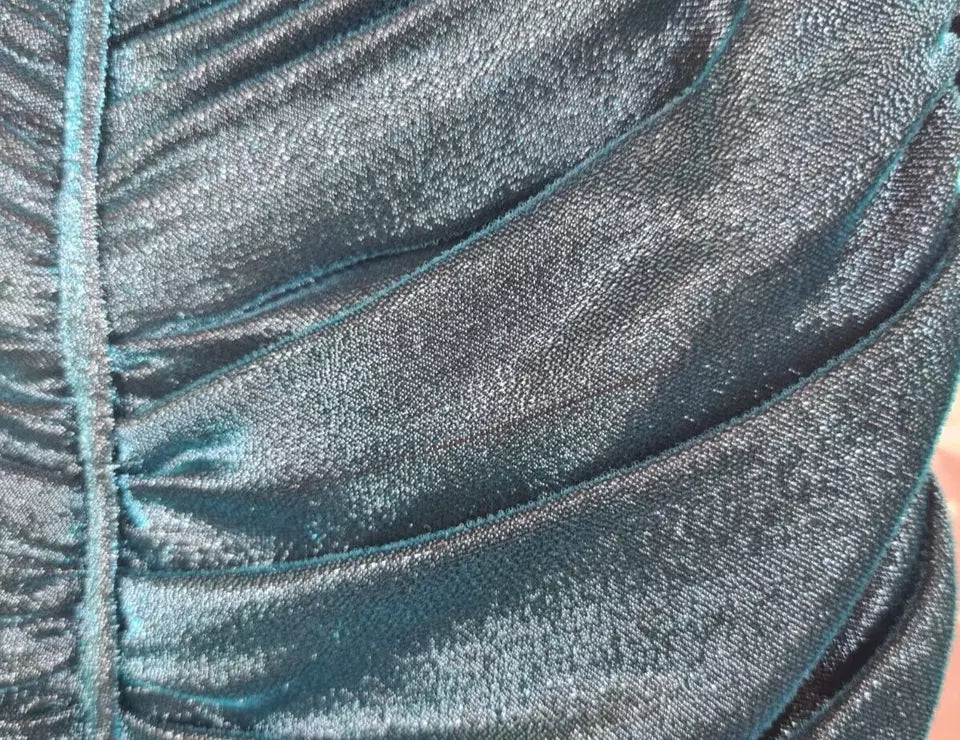 A turquoise bustier bodice draped midi dress with a shiny, textured fabric