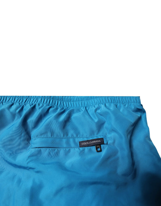 Blue swim shorts with logo on waistband