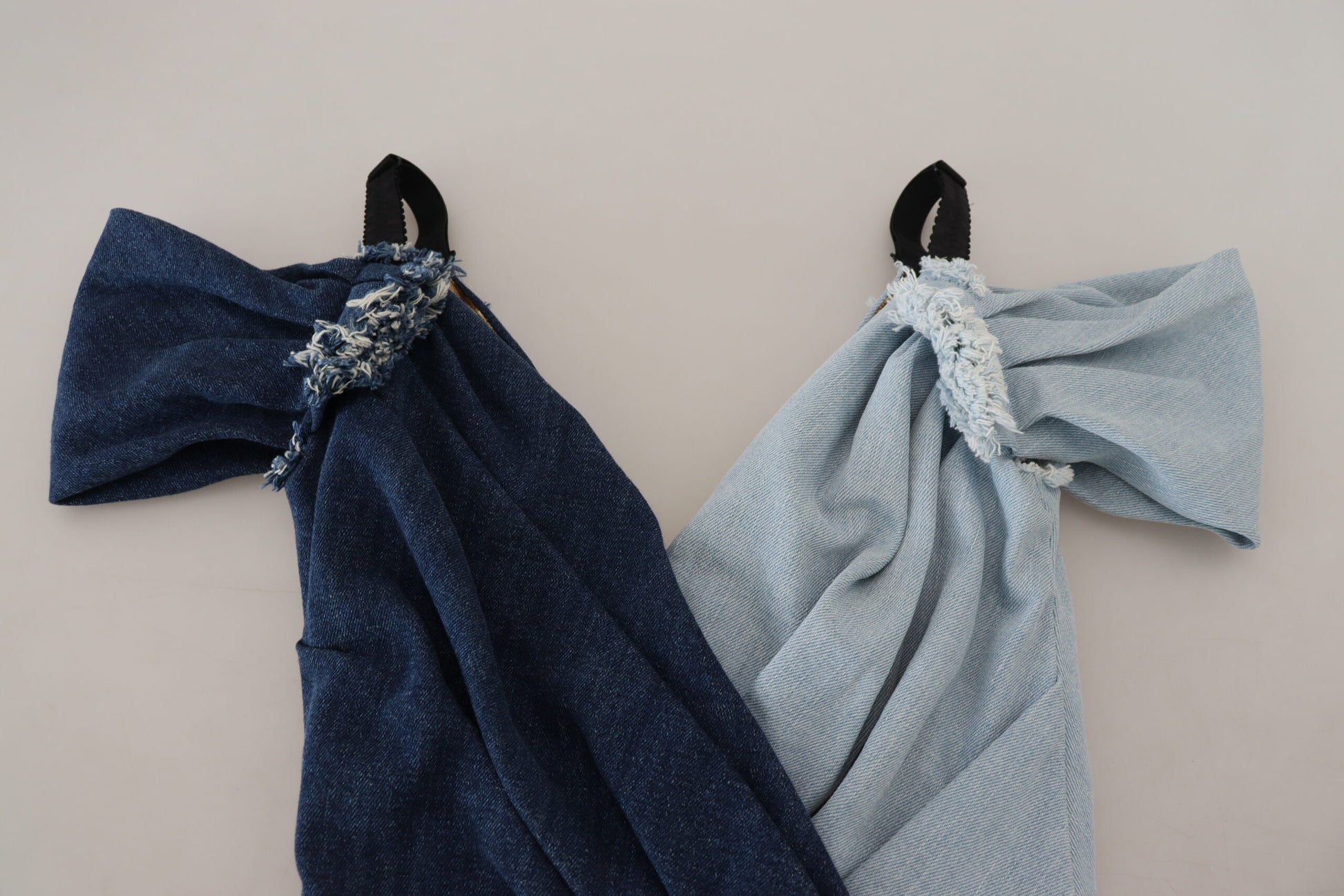 A blue denim dress with patchwork design and white trim