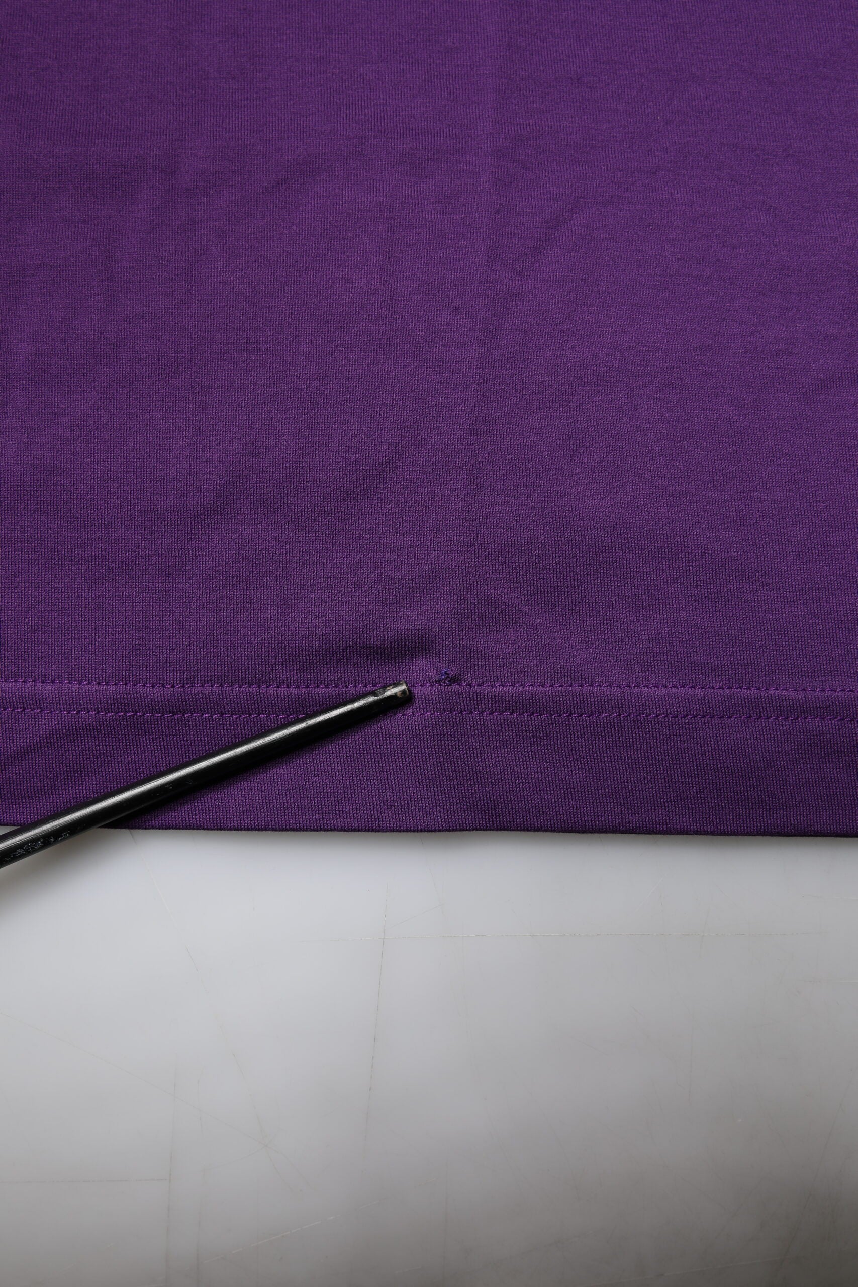 Purple fabric with a hole in it