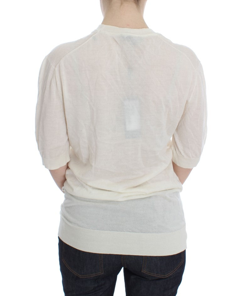 Back of a person wearing a light shirt and dark pants