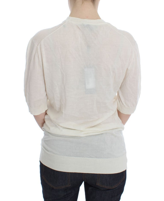 Back of a person wearing a light shirt and dark pants