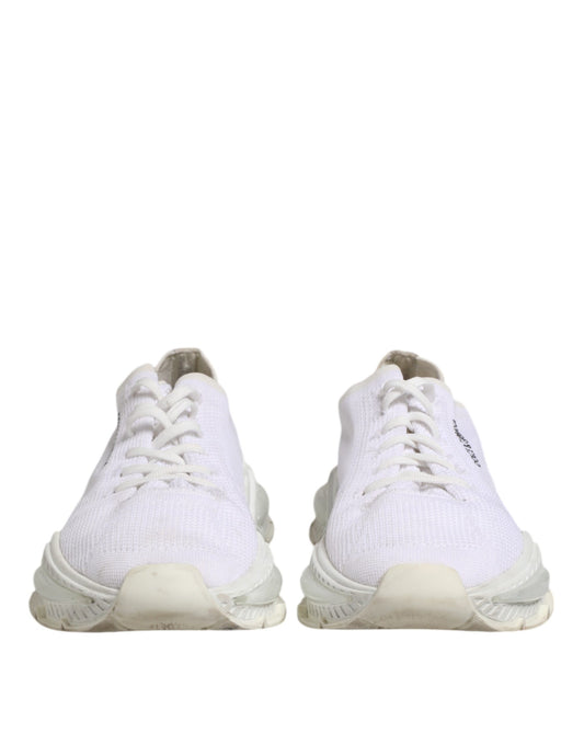 Pair of white sneakers with laces, featuring a low top design and branded logo on side