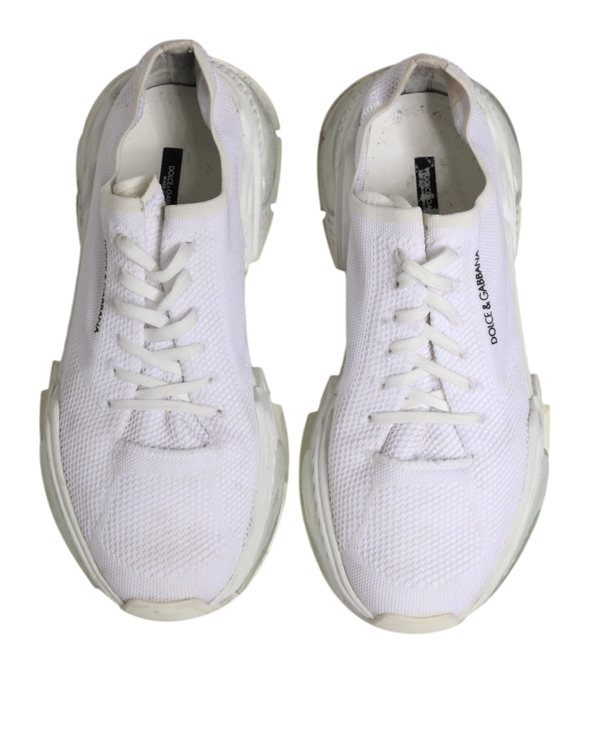 Pair of white sneakers with laces, branded logo on side and tongue